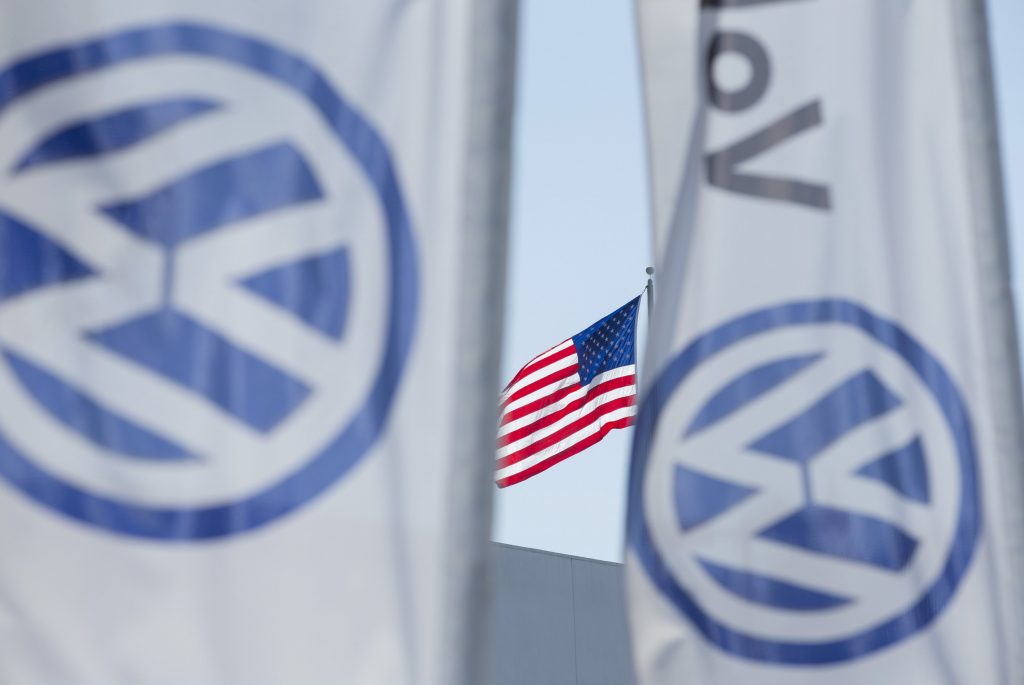 An American flag flies next to a Volkswagen car dealership in San Diego, California